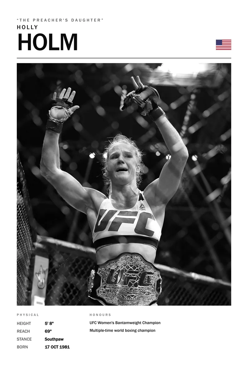 Holly Holm — Both arms up, the belt already around her waist